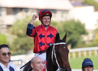 James McDonald celebrates after winning atop The Golden Scenery in Hong Kong.