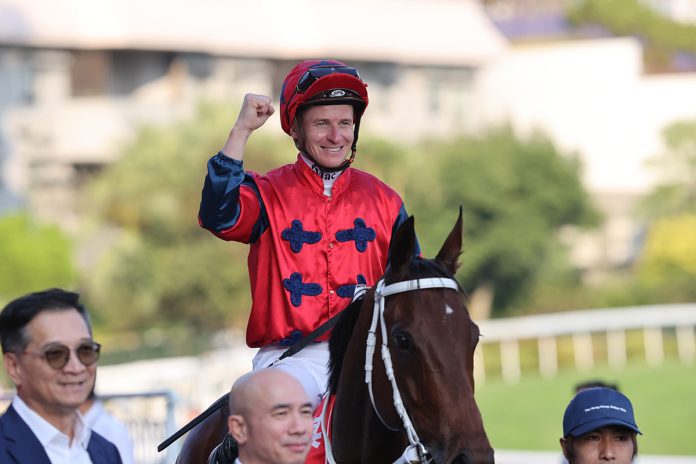 James McDonald celebrates after winning atop The Golden Scenery in Hong Kong.